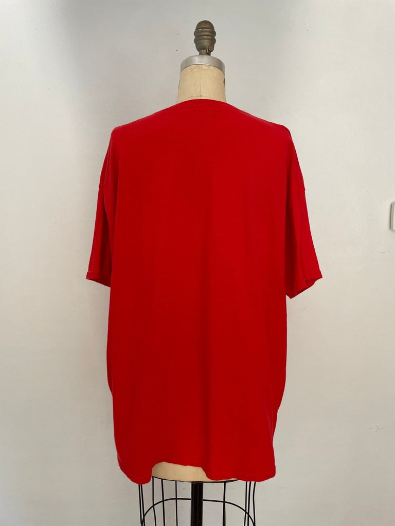 back of a handmade red cotton T-shirt featuring natural oil stain details, shown on mannequin against a white background