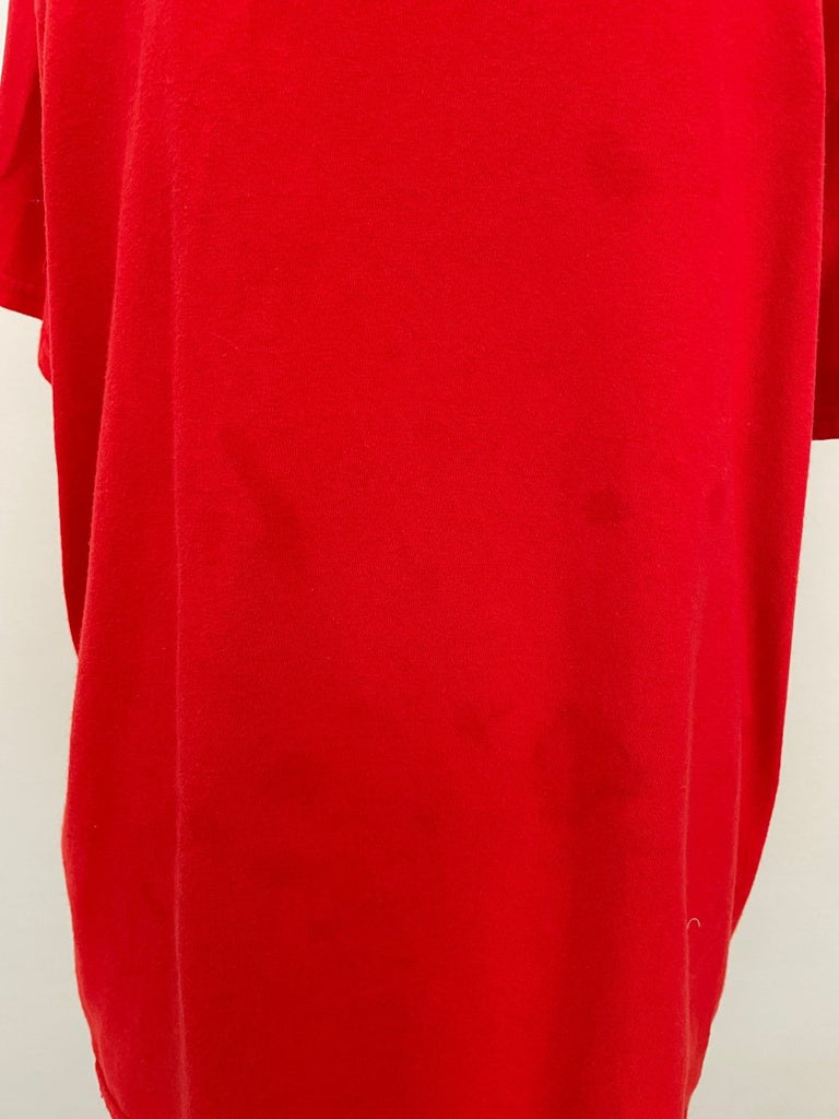 Handmade red cotton T-shirt featuring natural oil stain details, shown on mannequin.