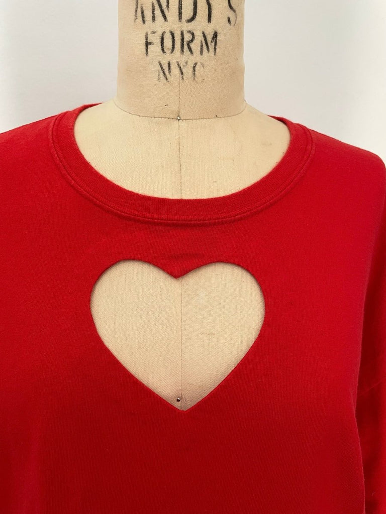 Handmade red cotton repurposed T-shirt with chest heart cut-out, shown on mannequin.