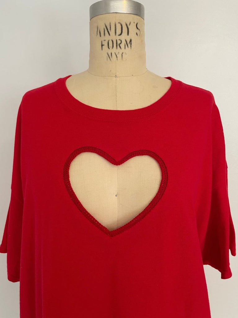 Red oversized crochet heart cut out T-shirt on a mannequin torso, showcasing a heart-shaped design with a crochet pattern around the edge.