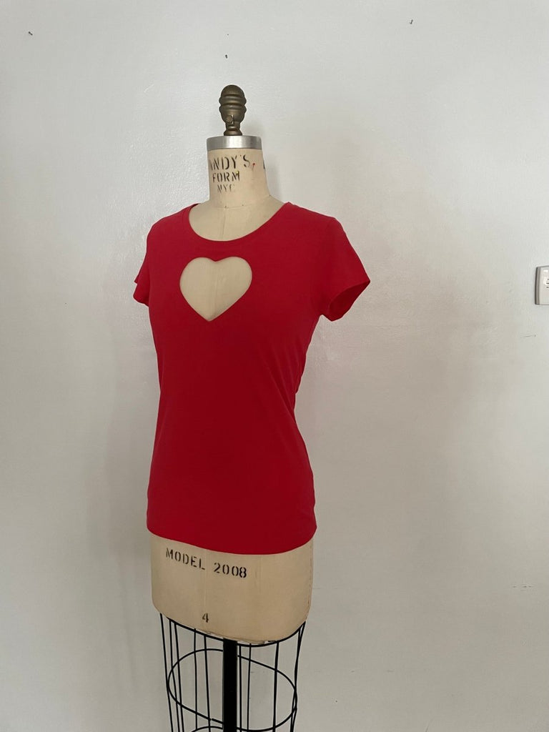 Red stretchy heart cut out t-shirt on a mannequin, with a crew neck design, displayed against a white background.