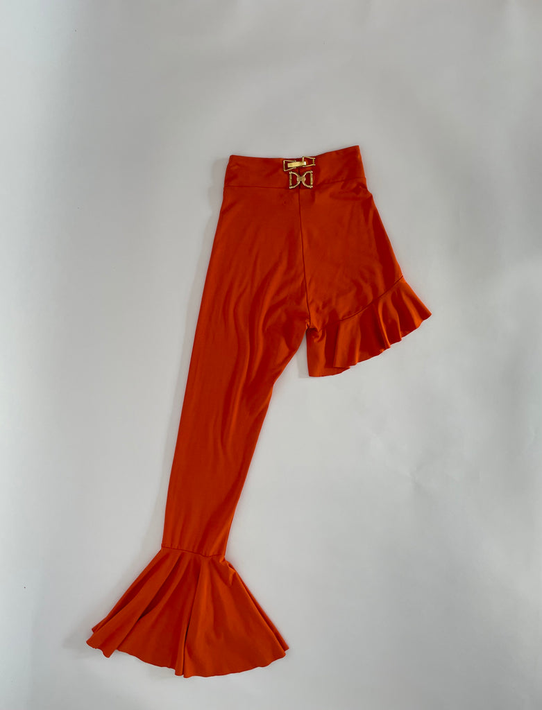 Orange asymmetrical ruffled leggings by Sarah Aphrodite with unique gold hardware, available in Small and Large.

