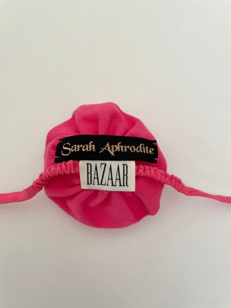 Handmade pink flower ankle accessory with elastic ties, crafted from upcycled fabric by sarah aphrodite