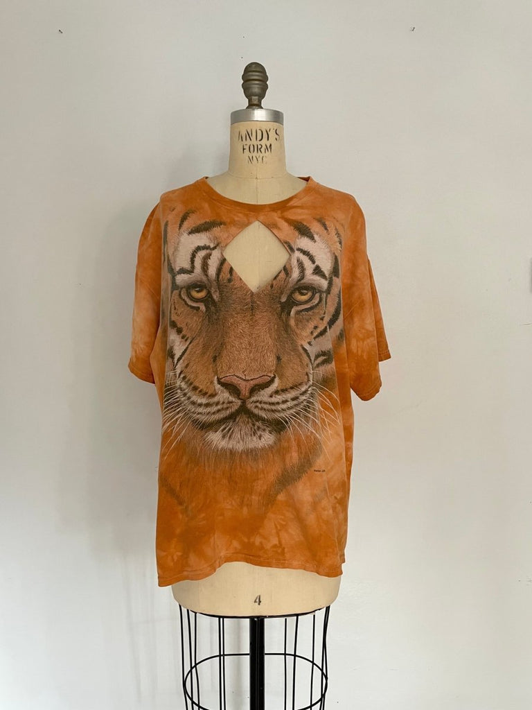 Handmade orange T-shirt with large tiger graphic and diamond-shaped chest cut-out, displayed on mannequin.