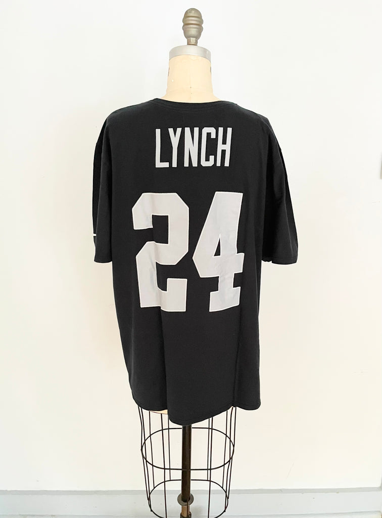 Oversized black t-shirt with a heart cut-out design and the number 24 printed on the front and the back, displayed on a mannequin.