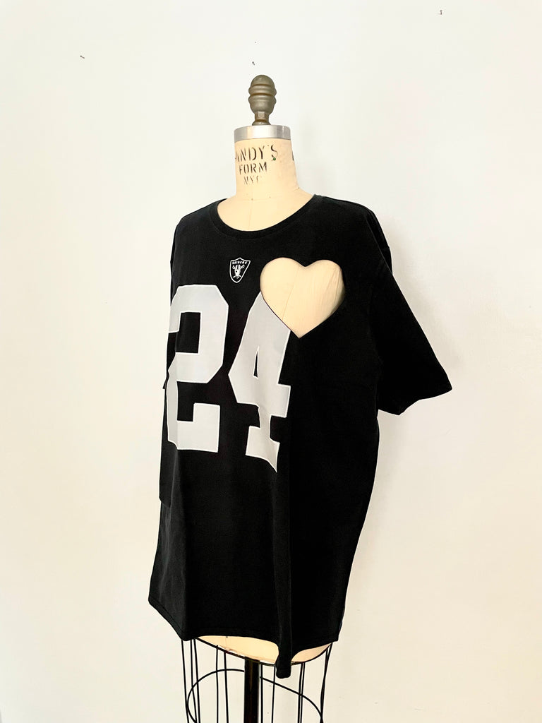 Oversized black t-shirt with a heart cut-out design and the number 24 printed on the front, displayed on a mannequin.