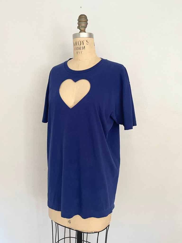 Ultramarine blue t-shirt with a heart cut-out design in the center, displayed on a mannequin at a side angle