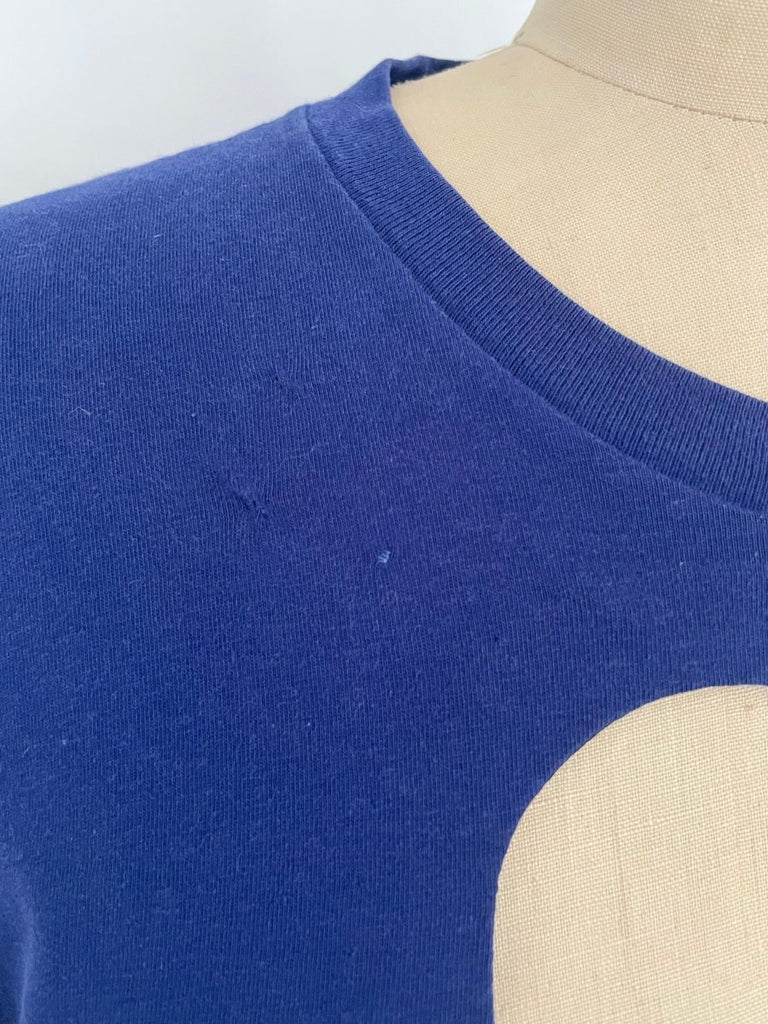 detail of Ultramarine blue t-shirt with a heart cut-out design 