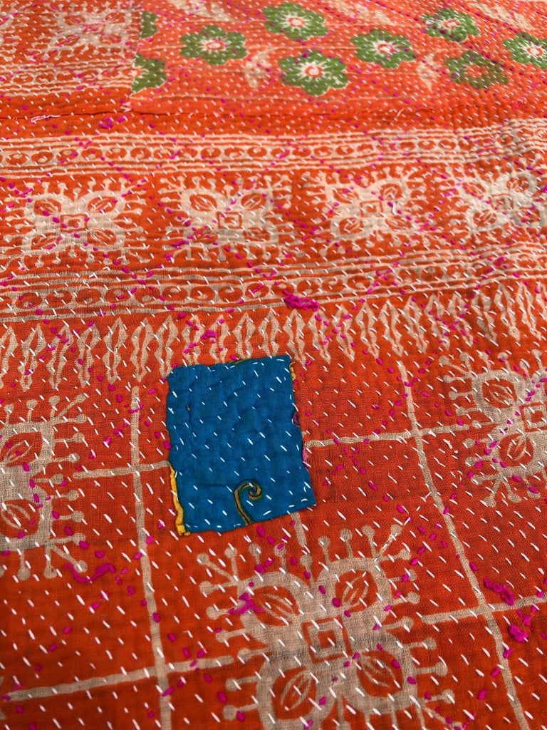 Close-up of a patterned fabric with a blue patch