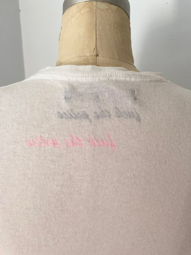 back of a white T-shirt with a print on the inside photographed on a mannequin