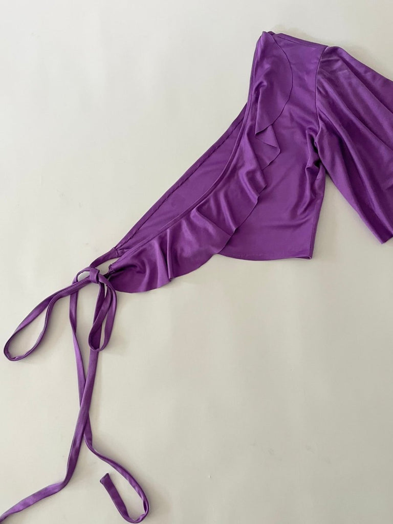 Purple top with ruffled neckline on a white background