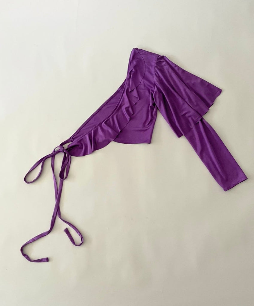 Purple top with ruffled neckline on a white background