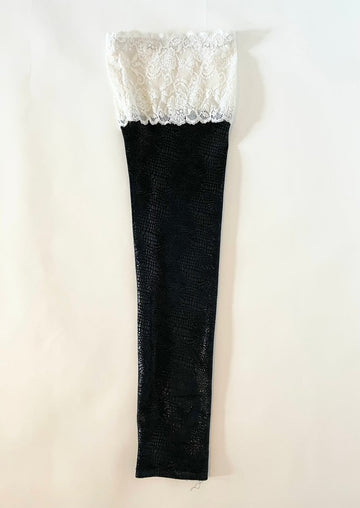 One-of-a-kind black shiny snake print leg piece with white salvaged lace trim by Sarah Aphrodite. Handmade, sustainable, and designed to fit sizes S–L.