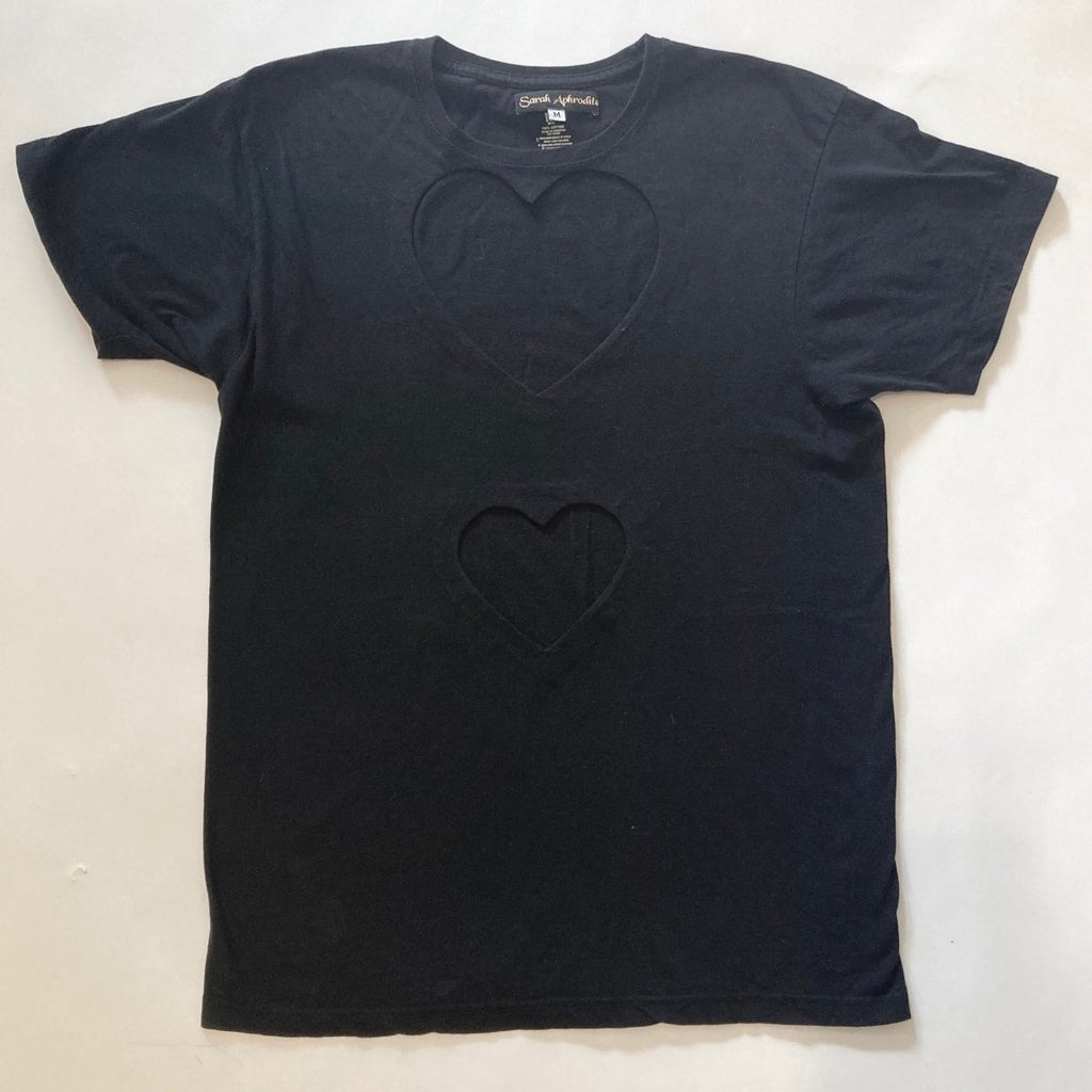 Fitted double heart cut-out t-shirt by Sarah Aphrodite, handmade from repurposed black or white cotton. Features two hand-cut heart openings, unique markings, and a fitted silhouette for layering or wearing solo.