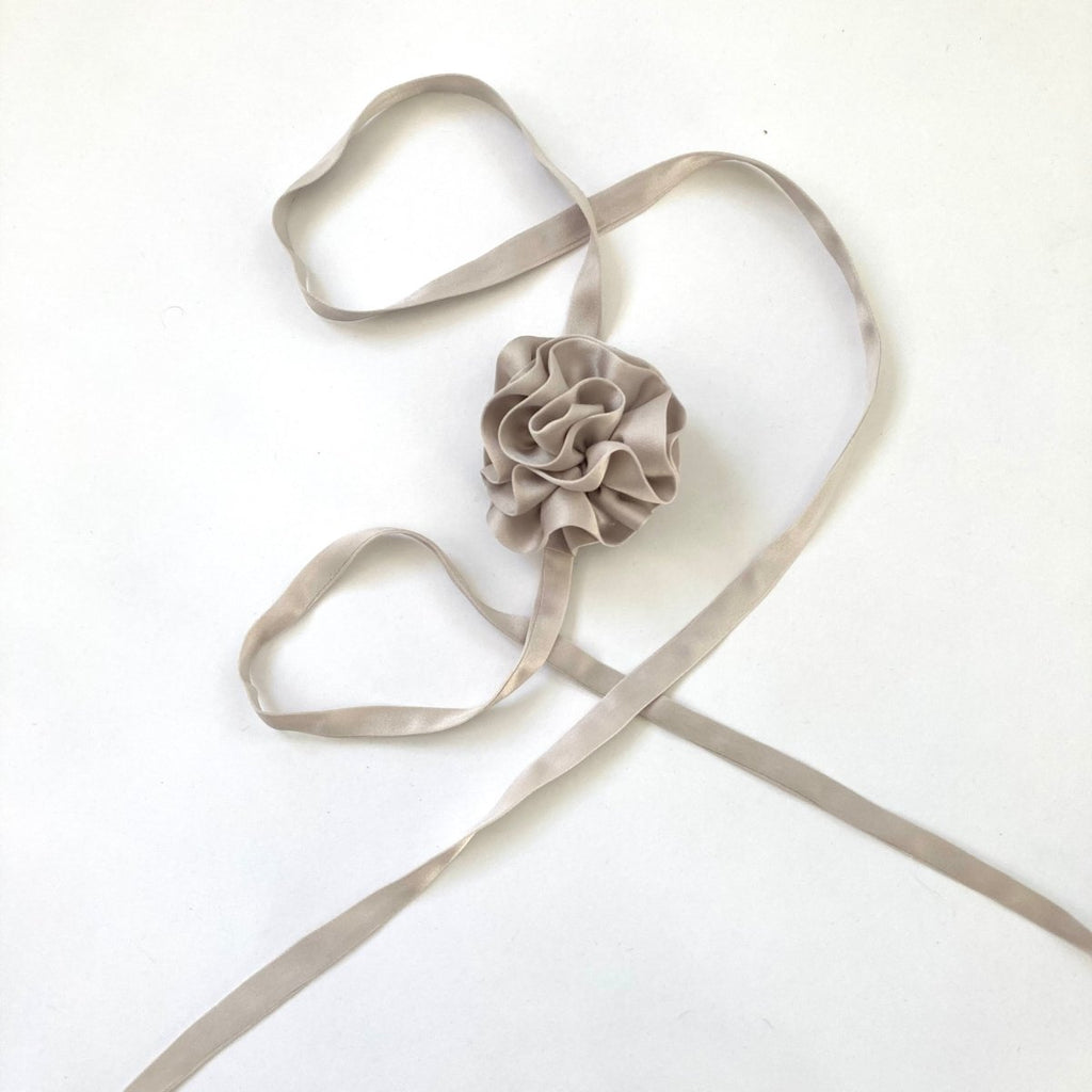 One-of-a-kind silk periwinkle flower accessory by Sarah Aphrodite, hand-sewn from upcycled fabric scraps. Versatile design with ties, worn as bracelet, anklet, neck, or arm accessory.