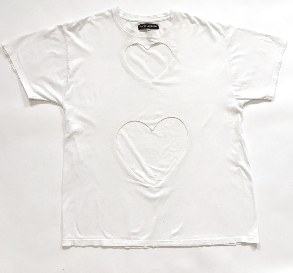 One-of-a-kind oversized t-shirt by Sarah Aphrodite, handmade from upcycled black or white cotton t-shirt. Features two hand-cut hearts, and unique markings for a casual, sexy, sustainable style.
