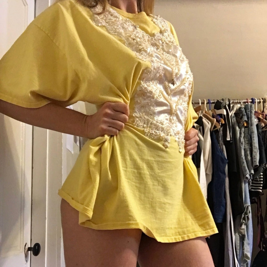 One-of-a-kind oversized vintage yellow cotton t-shirt by Sarah Aphrodite, featuring a satin wedding dress patch from the SA archive. One size fits all, handmade, sustainable, and unique.