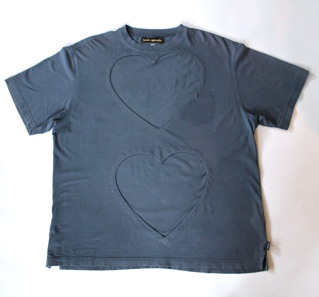 One-of-a-kind repurposed denim-blue double heart cut-out tee by Sarah Aphrodite, hand-sewn from a vintage t-shirt. Large heart openings for layering, soft washed fabric, one size fits all.