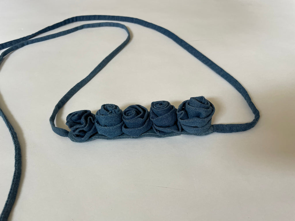 Handmade one-of-a-kind denim rose belt by Sarah Aphrodite. Crafted from repurposed denim scraps, sustainable and unique, versatile to wear around waist, shoulder, leg, arm, or ankle.