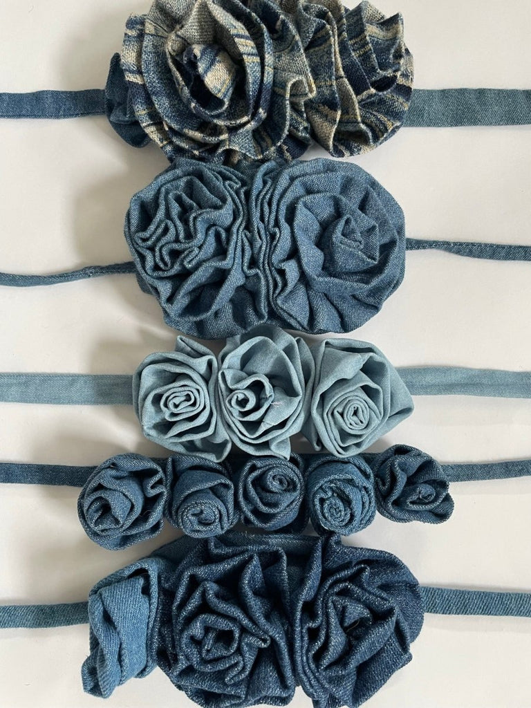 Handmade one-of-a-kind denim flower accessories by Sarah Aphrodite. Crafted from repurposed denim scraps, sustainable and unique, versatile to wear around waist, shoulder, leg, arm, or ankle.