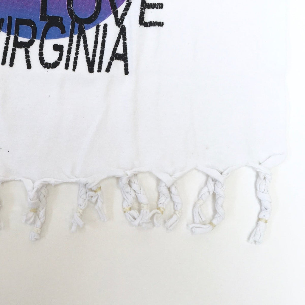 One-of-a-kind handmade ‘VIRGINIA BEACH’ cropped tee by Sarah Aphrodite, featuring a heart cut-out, fringe detailing, and crafted from vintage cotton. XS–S fit, unique markings from upcycled fabric.