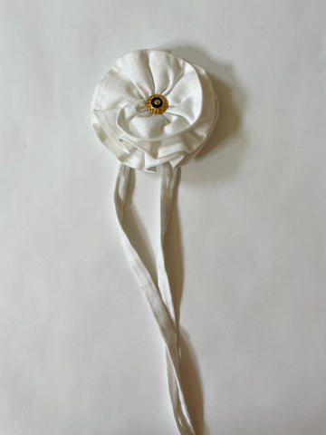 Handmade one-of-a-kind white flower accessory by Sarah Aphrodite, featuring a gold nautical button and made from upcycled SA scrap fabrics. Versatile wear as necklace, bracelet, anklet, upper arm, or garment embellishment.